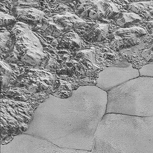  Mountains of ice along a portion of smoother ice planes on Pluto’s surface.